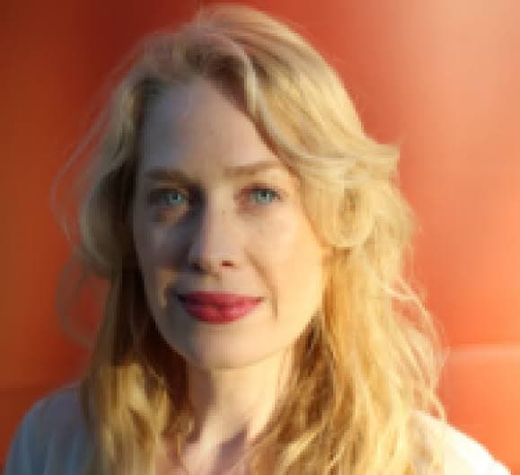 Professional portrait of a knowledgeable and friendly content writer, wearing smart casual attire, with a confident smile and a clean, modern background. The image reflects professionalism, trustworth